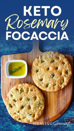 keto rosemary focaccia on a wooden cutting board with dipping sauces