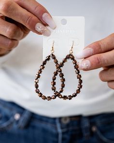 Tear drop earrings with alternating chocolate colored square and round beads Brown Metal Beaded Earrings With Ear Wire, Brown Faceted Beads Dangle Jewelry, Trendy Brown Teardrop Earrings, Brown Beaded Teardrop Jewelry, Brown Metal Beaded Drop Earrings, Elegant Teardrop Beaded Earrings In Brown, Elegant Brown Teardrop Beaded Earrings, Elegant Brown Metal Beaded Earrings, Brown Metal Beaded Dangle Earrings