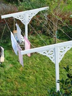 clothes hanging out to dry in the sun on an outdoor laundry line near some bushes