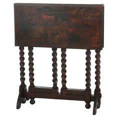 an old wooden table with two legs and a small shelf on the top that is turned upside down