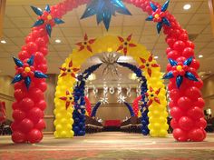 an archway decorated with balloons and flowers