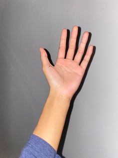 a person's hand reaching up into the air