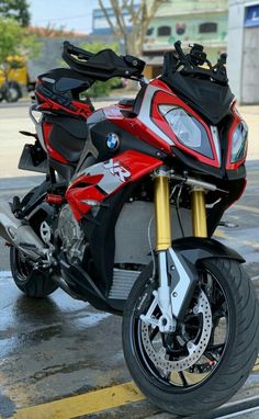 a red and black motorcycle parked in a parking lot