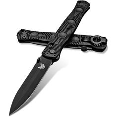 a black knife with an intricate design on it