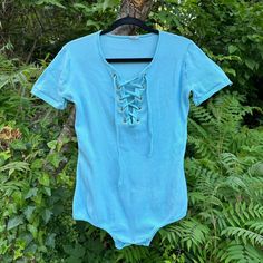 1970s Baby Blue Stretch Ribbed Shortsleeve Front Lace Body Suit. Tag size Large 16-18. One snap at the bottom is missing. Otherwise good condition. B 36-64 H 36-56 L 26 Leg Holes: 16-28" All sales are final. Reminder these items are vintage, expect wear & age to be present. I do my best to point out flaws. Measurements are taken in inches with the garment laying flat. Measurements are then doubled where appropriate (bust hips waist). Please note I ship about once every two weeks! *Please read ou Vintage Bodysuit, Lace Body Suit, Lace Body, Plus Size Vintage, Lace Bodysuit, Womens Bodysuit, Body Suit, Catsuit, Lace Front