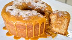 a bundt cake on a plate with a slice cut out and drizzled with icing