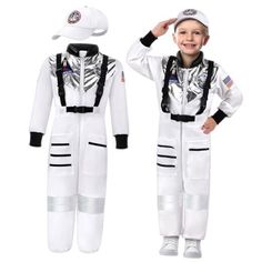 a young boy in an astronaut suit and cap standing next to another child's white space suit