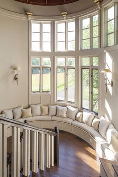 a curved couch sitting in the corner of a room