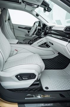 the interior of a car with all white leather