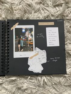 an open notebook with pictures and writing on the pages, along with a notepad attached to it