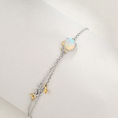 Great for both everyday ensembles and special outings, this Opal Bracelet features a man-made opal stone on a dainty silver chain with pops of gold. The outstanding opal stone glimmers with hints of blue and baby pink. 
 Product ID: JW5456 
 Includes: 1 bracelet 
 Material: 925 silver, man-made opal 
 Chain Length: 7.3  
 Uses: Bracelet, jewelry, accessories, fashion, style, etc. www.ccovv.com Rose Pale, Opal Bracelet, Opal Stone, Accessories Fashion, Bracelet Jewelry, Silver Man, Chain Lengths, Chain Length, Arm Band