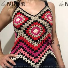 a woman is wearing a crocheted top while posing for the camera with her hands on her hips