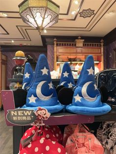 several wizard hats are on display in a store with polka dots and stars around them