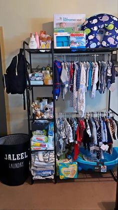 a baby's closet with clothes, diapers and other items on the shelves