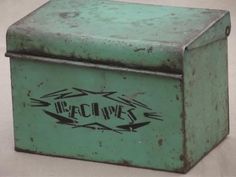 an old green metal box with the word wisconsin on it and arrows painted on it