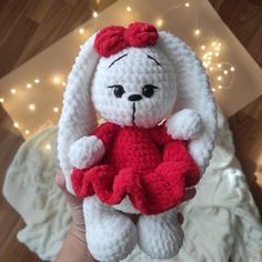 a crocheted white and red stuffed animal