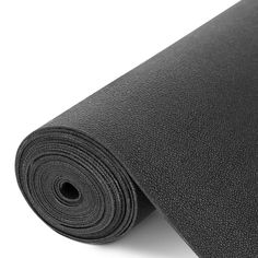 black yoga mat rolled up on white background