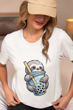 Get ready to steal the spotlight with our Sloth Hugging Boba Tea T-Shirt! This delightful unisex tee showcases a lovable sloth clinging to a cup of boba tea, making it an instant hit with animal lovers and boba aficionados alike. Crafted for comfort and style, this graphic tee is the perfect blend of fun and casual. It's an ideal gift for anyone who appreciates a mix of cuteness and leisure in their wardrobe. Embrace the joy of a relaxed vibe and a touch of playfulness with this unique shirt tha Tea Making, Animal Love, Boba Tea, Unique Shirt, Unisex Design, Sloth, Top Tee, Solid Black, Graphic Tee