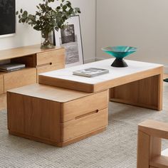 a living room with furniture and a vase on the coffee table in front of it