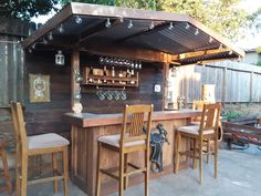 an outdoor bar with wooden chairs and shelves