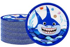 a blue party plate with an image of a shark on it and lots of other plates