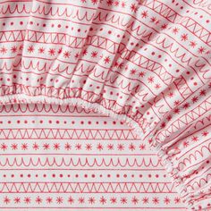 a red and white blanket with snowflakes on it