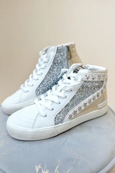 Add a touch of sparkle to your style with the Bailey High Top Sneakers. These leather lace-up shoes feature a shimmery finish and a comfortable high-top silhouette, perfect for everyday wear. Step up your sneaker game today!

-Gold/Silver Multi

-Runs True to Size Cowgirl Couture, Sneakers Street, Wedge Heel Boots, Jumpsuit Outfit, Sneaker Games, Plus Size Shopping, Leather Lace, Platform Shoes, Online Boutiques