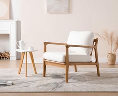 a chair and table in a room with white walls, wood floors and flooring