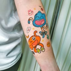 a person with a cartoon tattoo on their arm