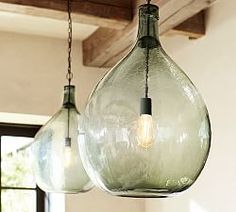 three glass hanging lights in a kitchen