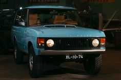 a blue pick up truck parked in a garage