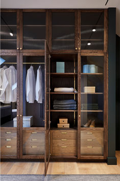 A bespoke minimalist, wooden wardrobe with a clean, modern aesthetic. The handcrafted, wood-framed wardrobe, crafted by master artisans in our workshop, allows light to pass through to reveal its contents behind the fluted glass panels. The custom-made wardrobe creates a dressing room connecting the master bedroom to the ensuite bathroom, so you can easily dress to impress with your best autumn and winter outfits each morning. Kitchen Architecture, Hague Blue, Palmetto Bluff, Luxury Closets Design, Dressing Rooms, Dream Closets, Closet Inspiration, Room Closet, Design Exterior