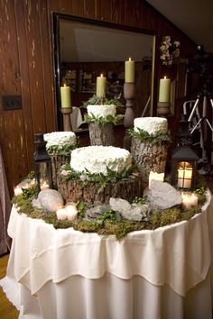 a table topped with lots of cakes and candles