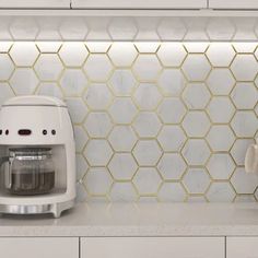 a kitchen counter with a blender, toaster and coffee pot on it in front of a white tiled backsplash