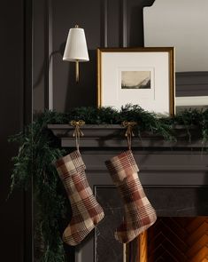 christmas stockings hanging from a fireplace mantel