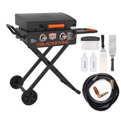 the blackstone bbq portable grill with accessories including hoses, and tongs