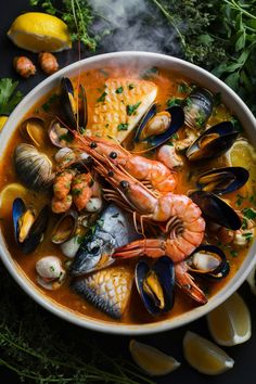 A steaming seafood stew with shrimp, mussels, fish, and herbs, garnished with lemon wedges. French Seafood Recipes, Mussels Soup Recipe, Mixed Seafood Soup, French Mussels Recipe, French Fish Soup, Bouillabaisse Recipe Seafood, Bouillabaisse Recipe, Gourmet Food Plating