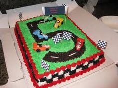 the birthday cake is decorated with cars and race track designs on it's sides