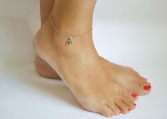 A minimalist Om anklet with silver tone Om charm. ॐ (The Om is a Hindu Symbol of the Absolute). Perfect for everyday, casual look. Great as a gift or for yourself. Om material: silver tone alloy metalChain material: stainless steel (waterproof)The anklet in the photo is 8 1/2" (21.5cm) long plus a 1 1/2" (4cm) extension. If you would like a different length, you can choose your option from the dropdown menu.This anklet is great as a gift for a woman or a girl. All of our jewelry comes wrapped an Hindu Symbol, Hindu Symbols, Om Bracelet, Anklet Silver, Om Charm, Charm Anklet, Catholic Jewelry, Yoga Jewelry, Silver Anklets