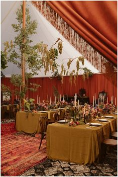 a tent with tables and chairs set up for a formal function in the middle of it