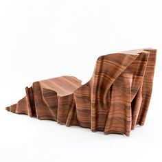 an unusual wooden sculpture is shown against a white background with the image of mountains made out of wood