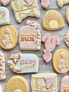 baby shower cookies are arranged on a table