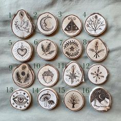 twelve wood slices with designs on them are arranged in order to show the size and shape