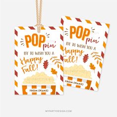 two tags with the words pop fun and happy fall written on them, hanging from strings