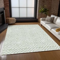 a living room with white furniture and a large rug in front of a window on the floor