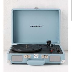 an old - fashioned record player in a suitcase with the word crosley on it