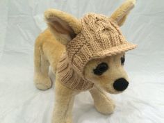 a stuffed dog wearing a knitted hat