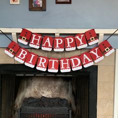 a happy birthday banner hanging over a fireplace