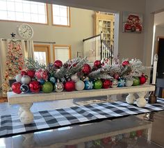 a table with christmas decorations on it in a room decorated for the holidays and holiday season