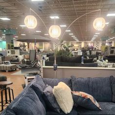 a blue couch with pillows on it in a store